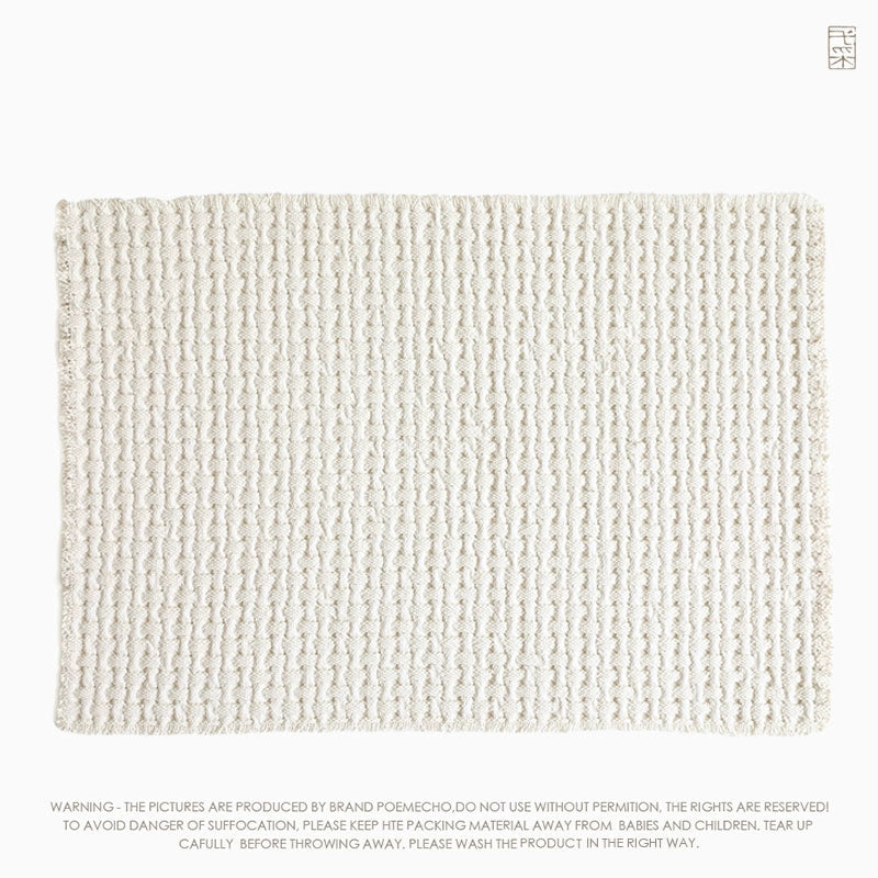 Beige woven cotton throw blanket, textured with a repeating pattern.
