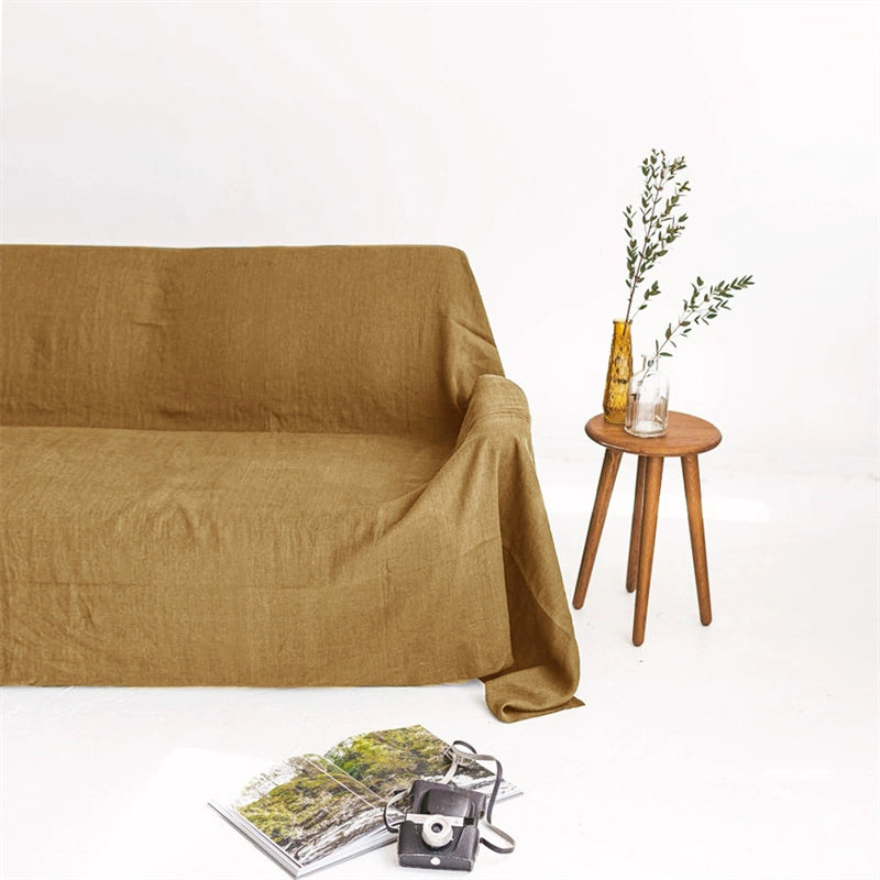 Mustard yellow linen sofa throw blanket draped over a sofa, cozy living room decor.