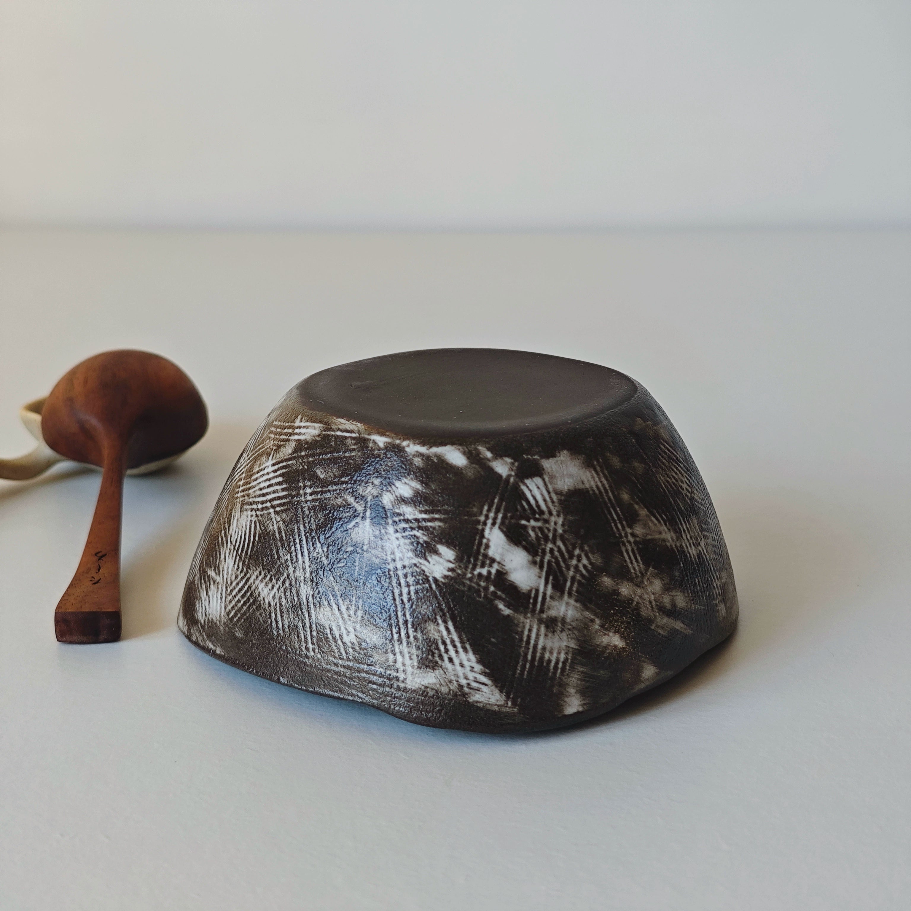 Hand-painted ceramic bowl & spoon set, black & white floral design.