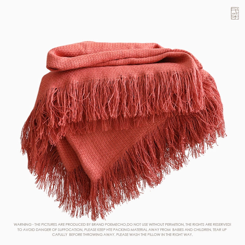Russet linen throw blanket with textured weave and fringe trim.