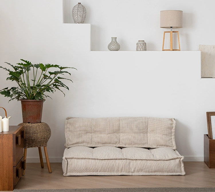 Beige modular sofa, tufted cushions,  modern living room design.
