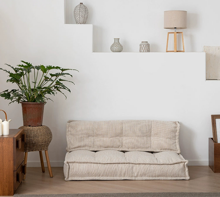 Beige modular sofa, tufted cushions,  modern living room design.
