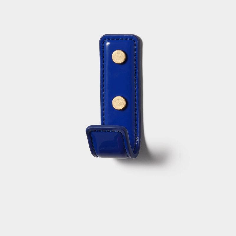 Shiny royal blue leather wall hook with gold accents. Colorful leather wall hooks.