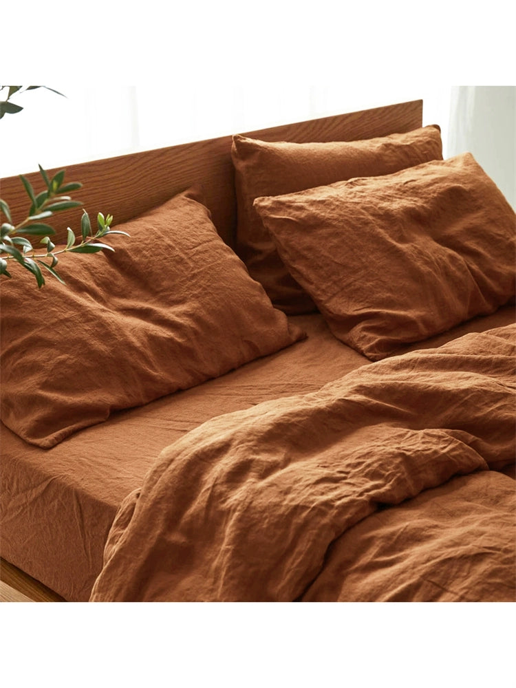 Terracotta natural linen bedding set on wooden headboard. Soft, comfortable bedding.