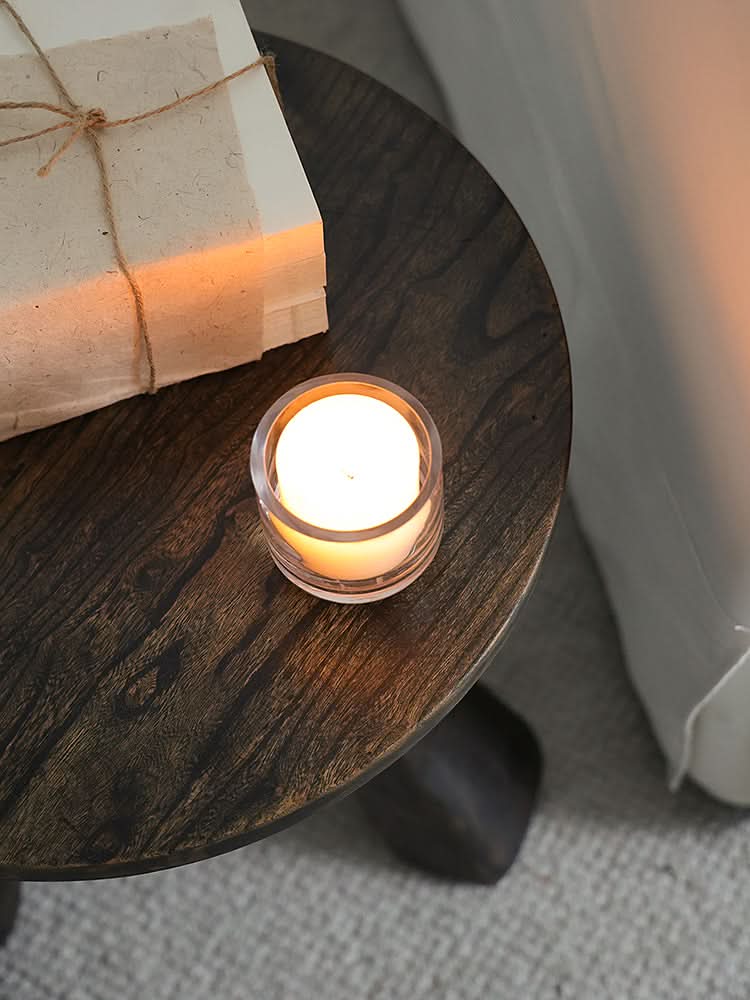 Rustic Wooden Side Table with candle and books, adds warmth to your living space.