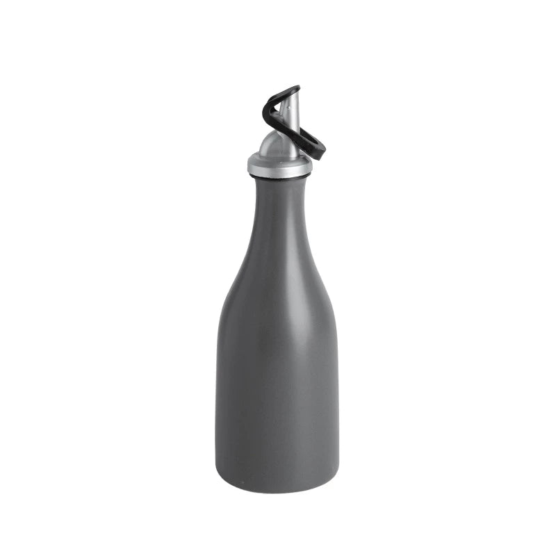 A minimalist ceramic oil dispenser bottle with a dark pour spout, set against a neutral background.