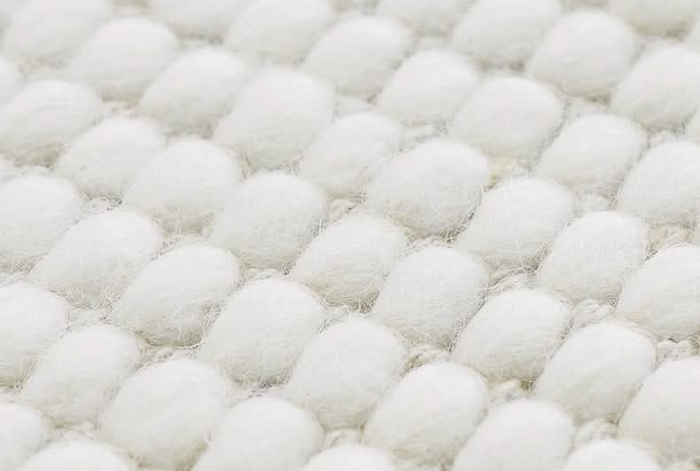 Close-up of Wool Handwoven Cream Rug texture with soft, rounded loops.