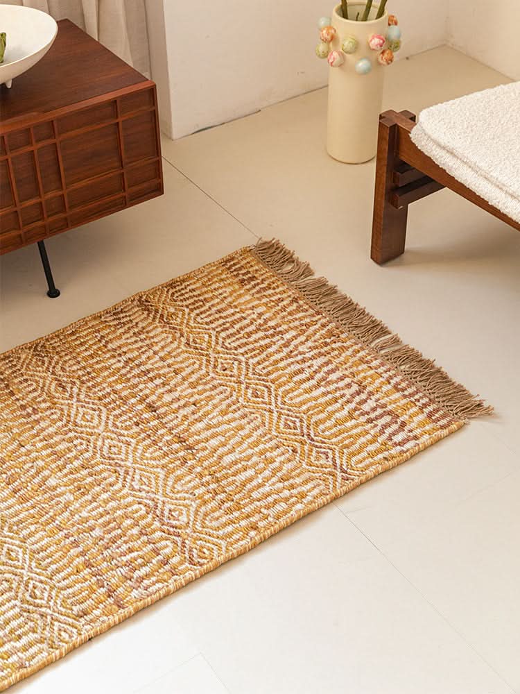 Woven Natural Area Rug in ochre and white with diamond pattern, fringed edges.