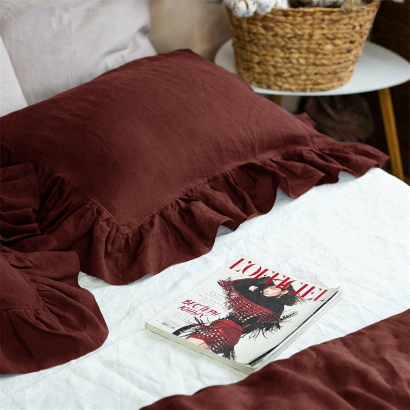 Rustic Linen Pillowcases with Frills - Set of 2 in deep red, textured fabric on a white bed.