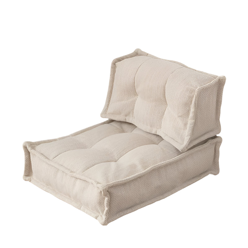 Modern beige fabric modular sofa with tufted cushions, comfortable living room furniture.