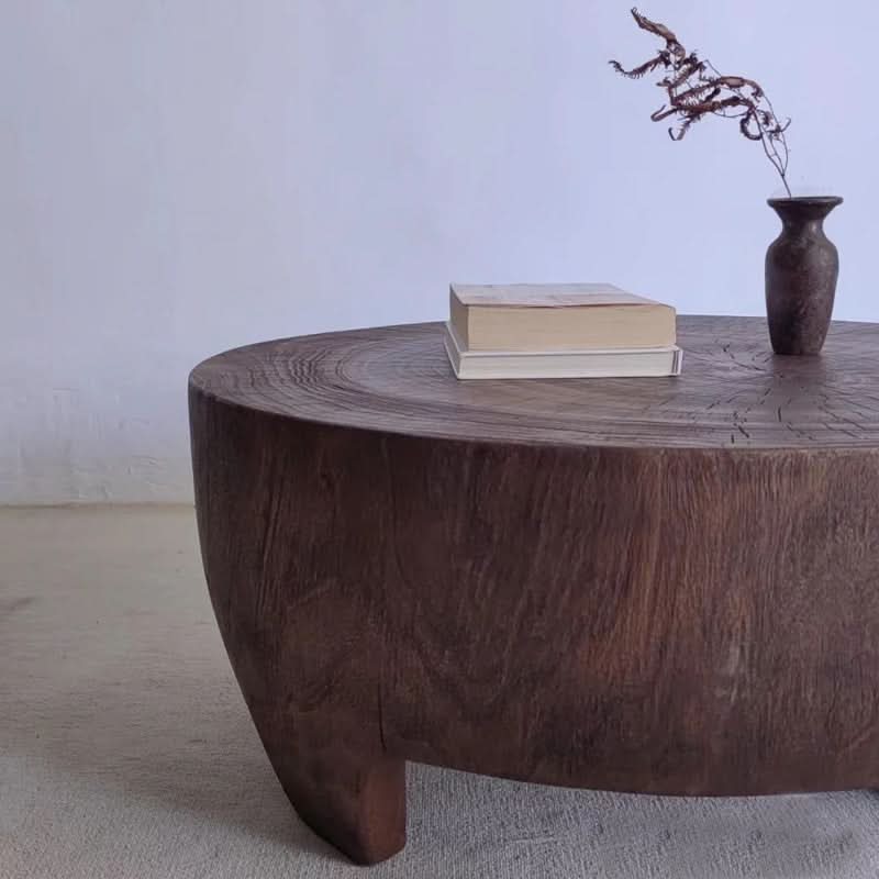 Rustic raw wood coffee table with books and a vase. Unique home decor.