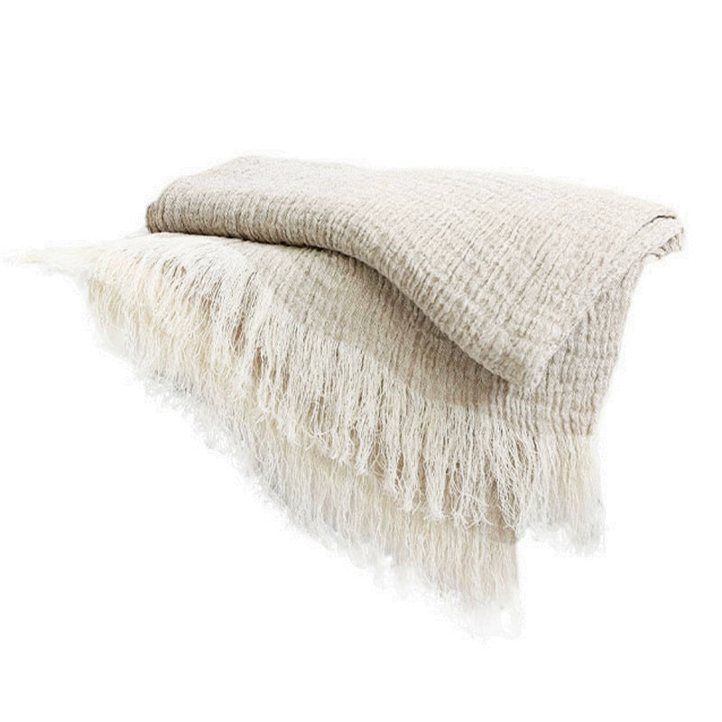 Light beige linen throw blanket with delicate fringes. Soft textured linen.