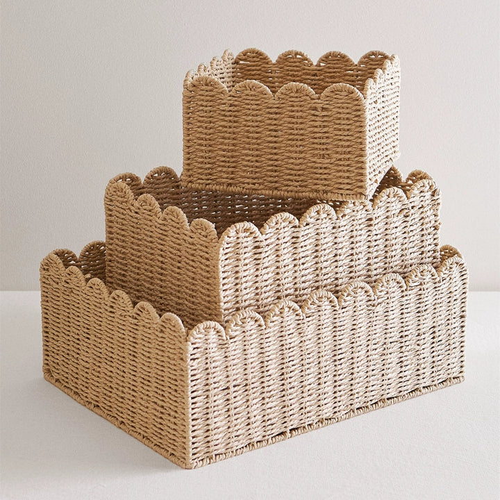 Set of 3 light beige rattan storage baskets with scalloped edges.  Stacked, woven design.