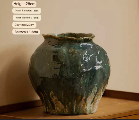 Wabi-Sabi Distressed Rustic Vase with dark green, drippy glaze, on a wooden shelf.