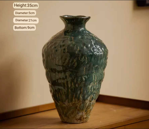 Wabi-Sabi distressed rustic vase with dark green glaze, textured ceramic home decor on wooden surface.