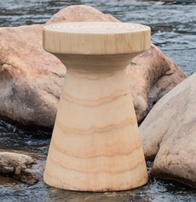 Light wood stool, customizable size, beside river rocks and water.