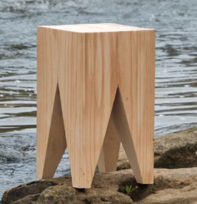 Natural wood stool with unique V-shaped legs, perfect for customizable home decor.
