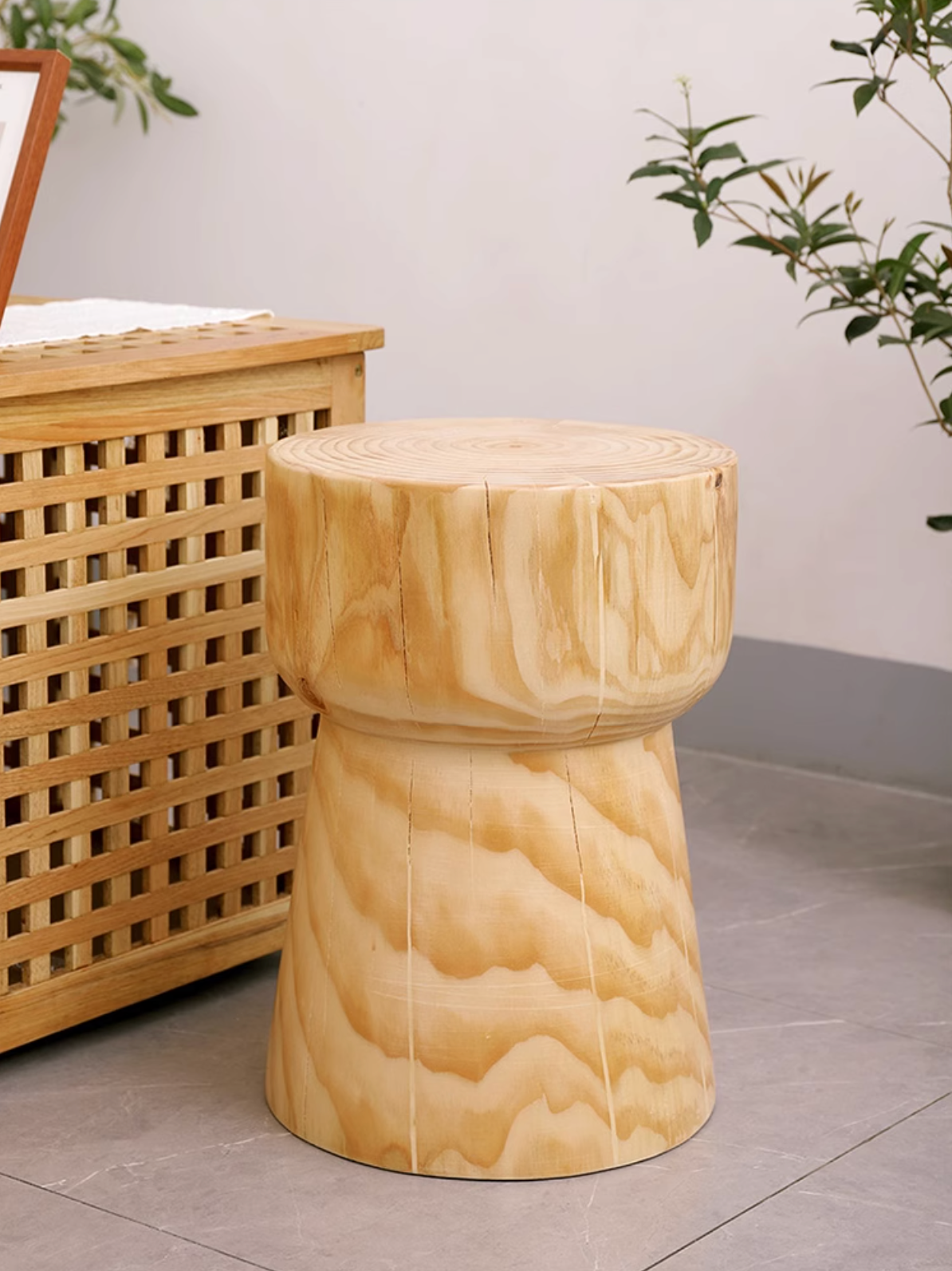 Natural wood stool with customizable size, featuring a unique grain pattern on a tiled floor.