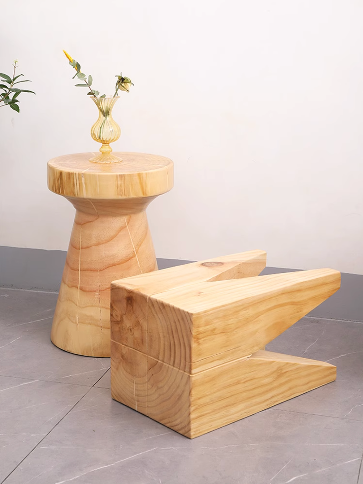 Two natural wood stools, one rounded, one angular, customizable size.