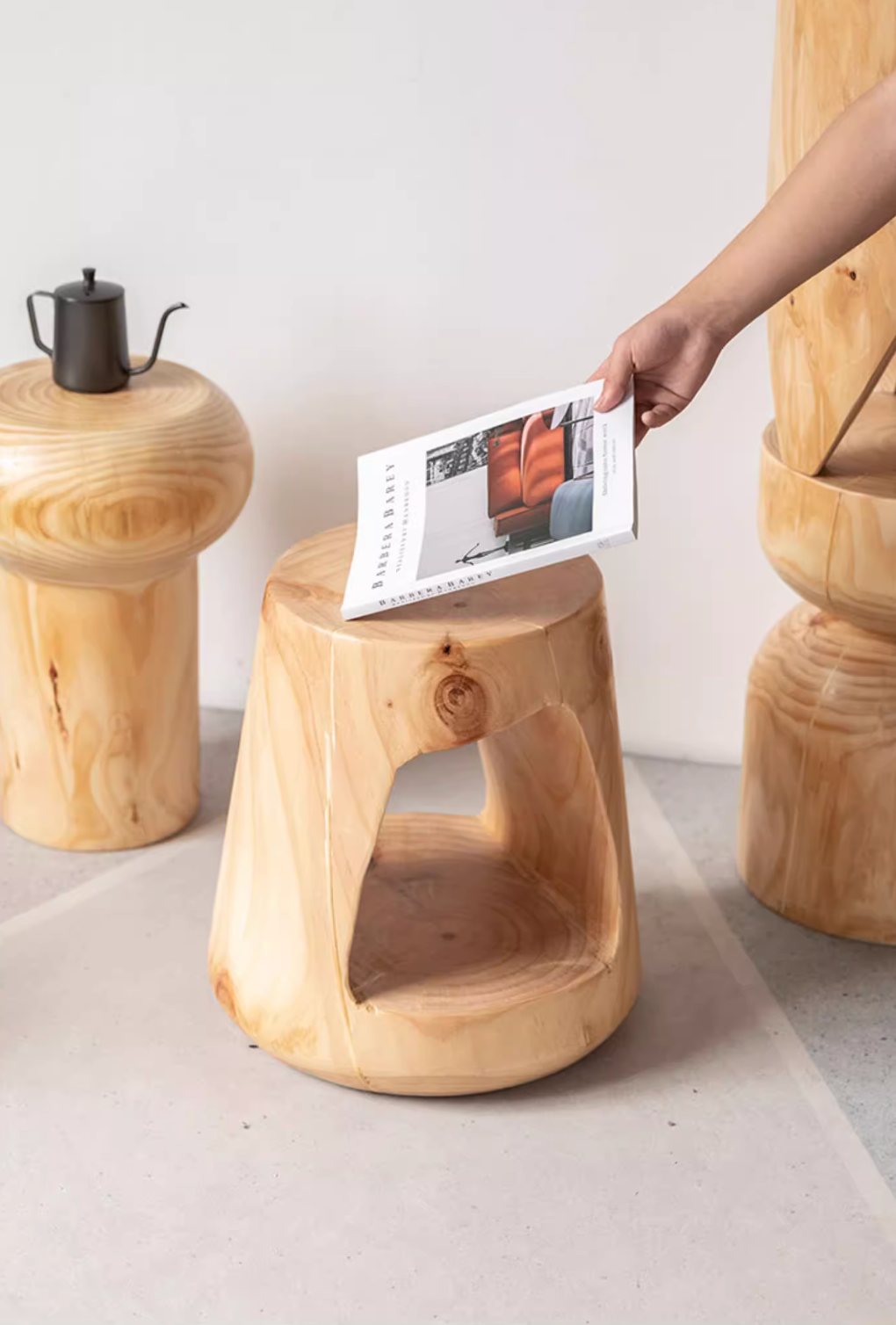 Natural wood stools, customizable size, shown with a book and kettle.