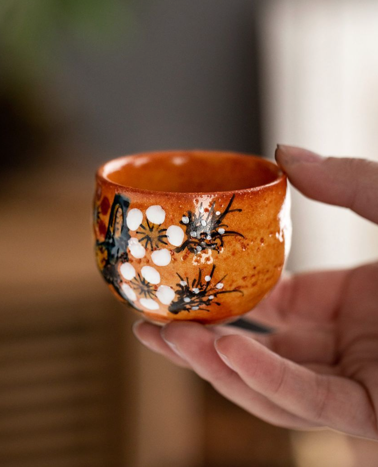 Orange ceramic cup with floral design from Five-Herb Flower Tea Cup Set 2.03 oz/60ml.