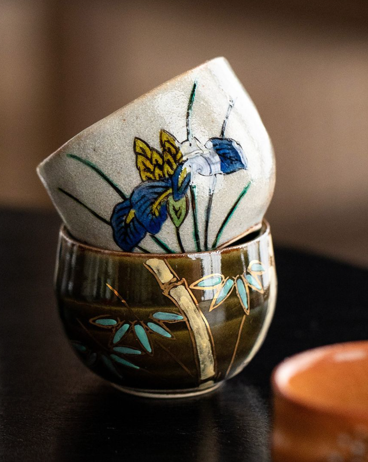 Hand-painted ceramic Five-Herb Flower Tea Cup Set with iris and bamboo designs.