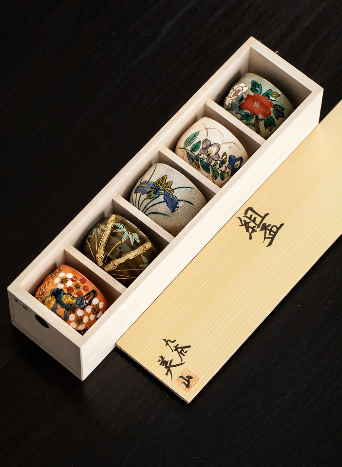 Five-Herb Flower Tea Cup Set: five decorative ceramic cups with floral motifs in a wooden box.