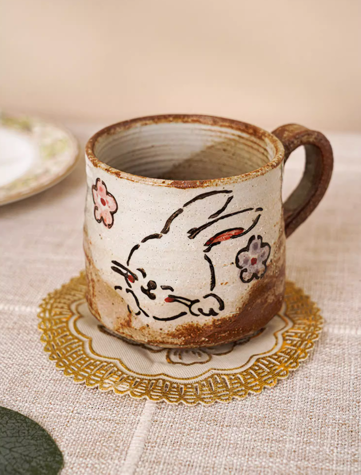 11oz hand painted coffee mug with cute bunny and floral design on textured ceramic.