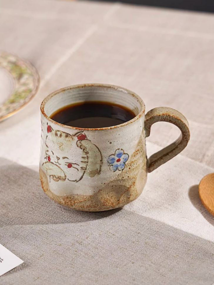 Hand painted 11oz coffee mug with cute cat design, beige ceramic with rustic finish.