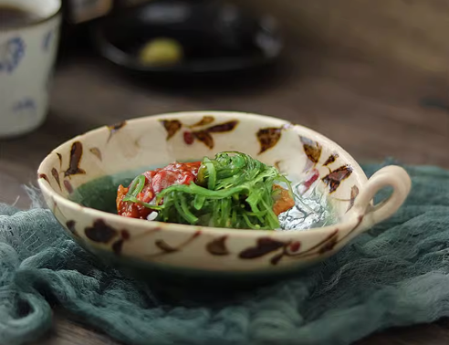 Japanese Ceramic Bowl With Handle, ornate floral design, green seaweed salad.