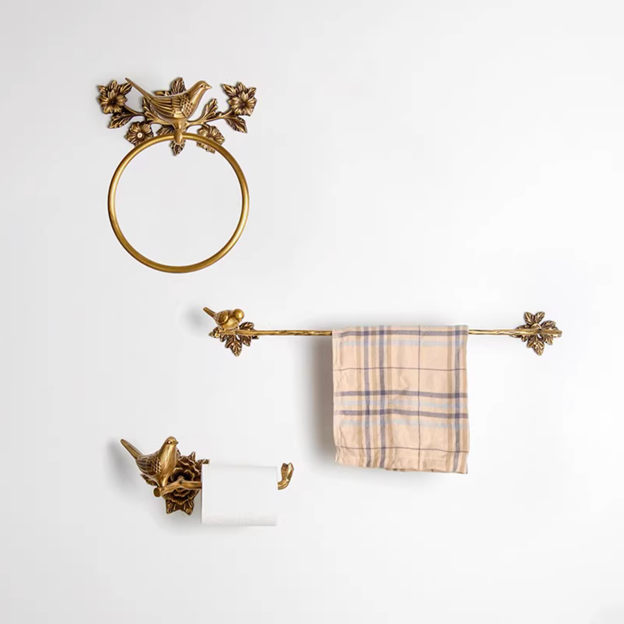 Brass Bird Bathroom Set: gold towel rack, toilet paper holder, and ring holder on white wall.