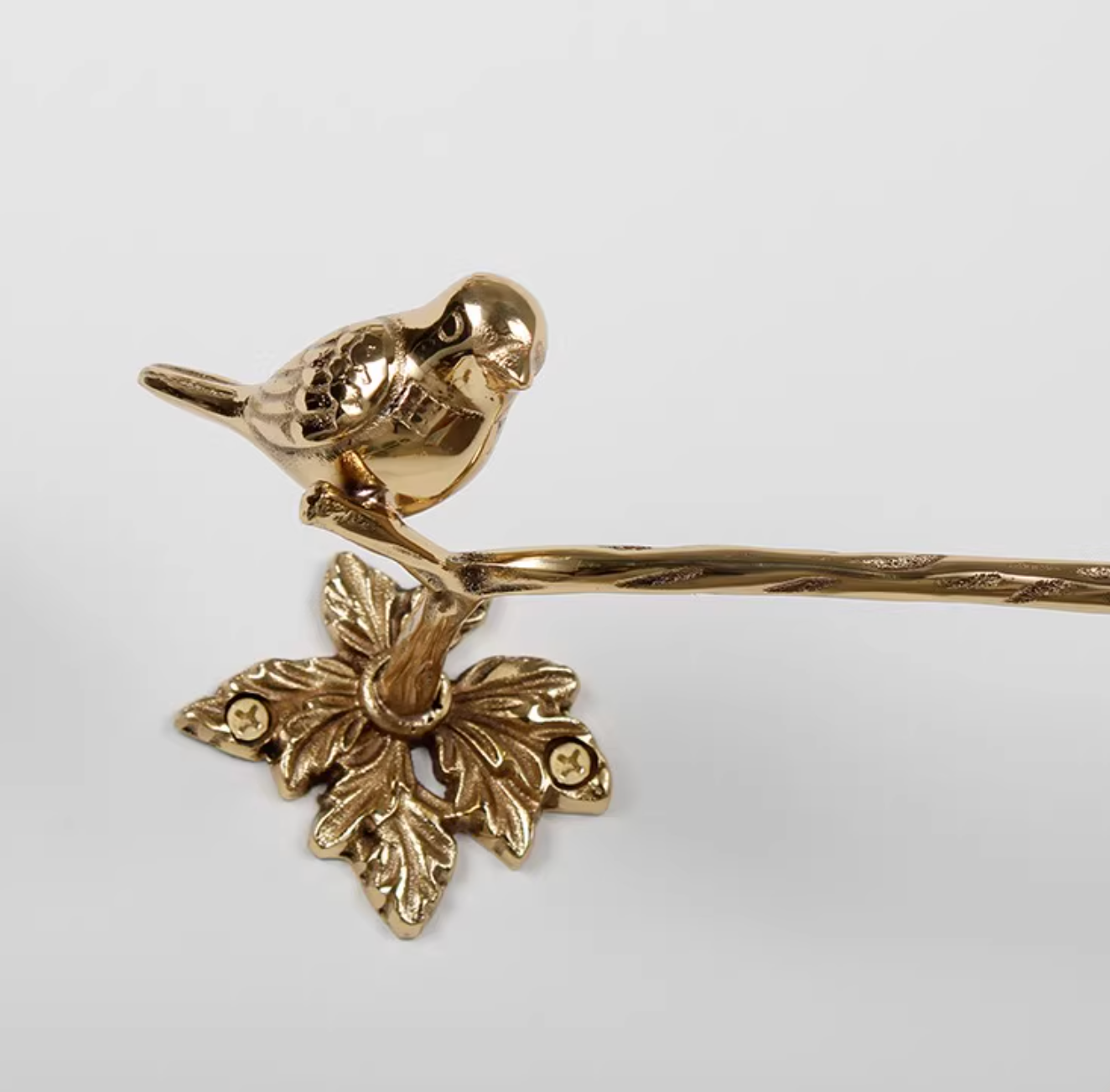 Brass bird bathroom set towel rack and toilet paper holder on white background.