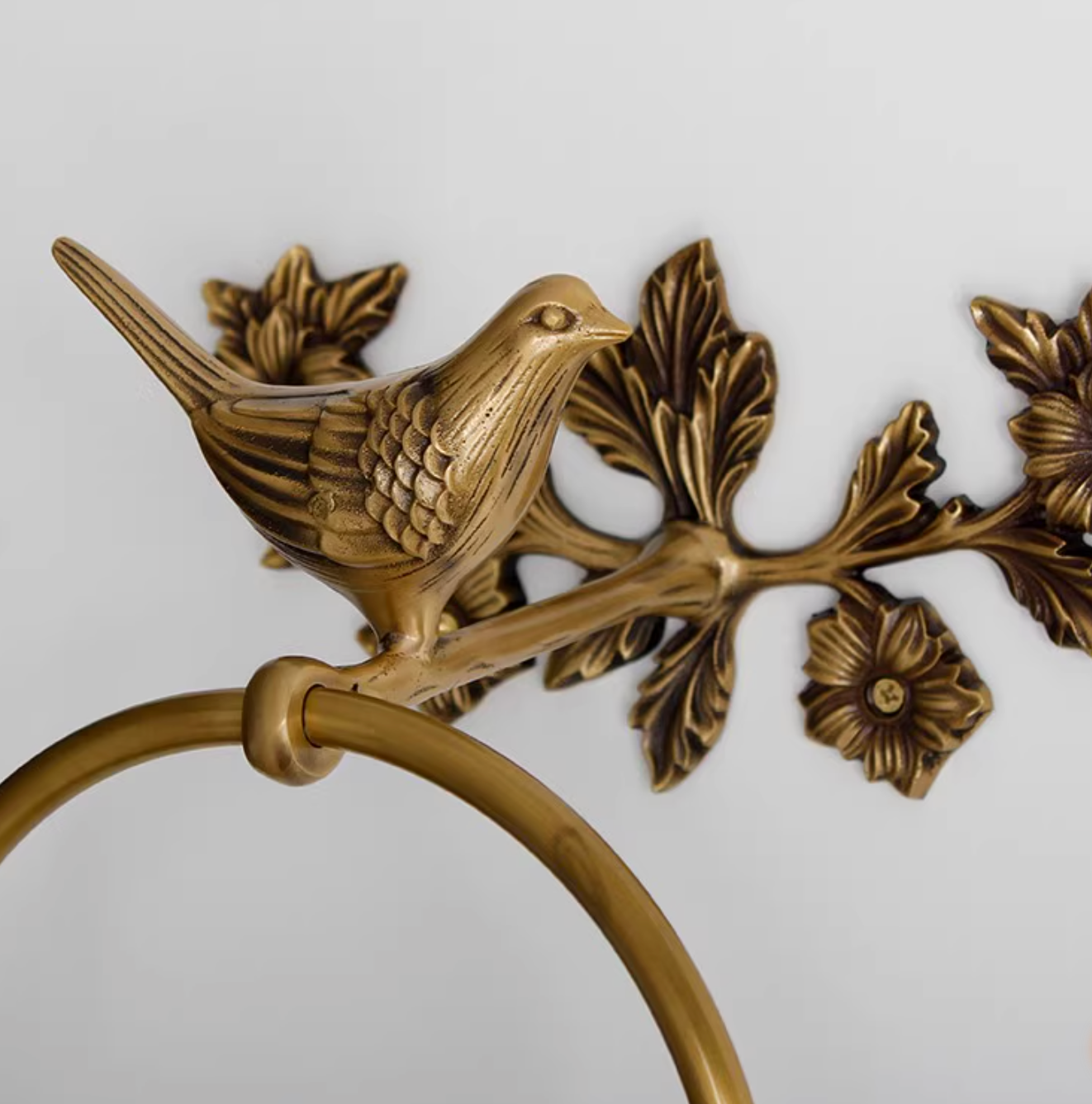 Brass bird bathroom set towel rack and toilet paper holder, ornate floral design.