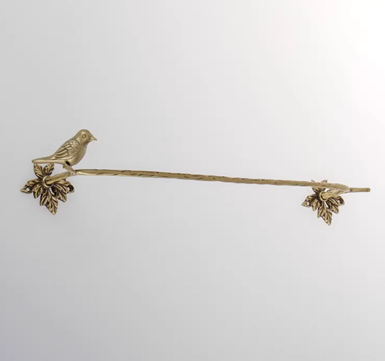 Brass bird bathroom set towel rack and toilet paper holder with leaf accents.