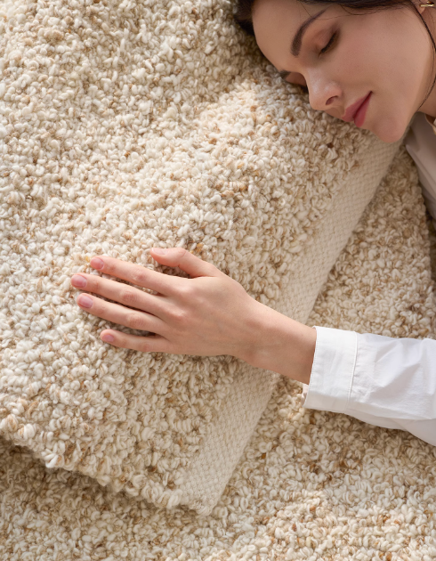 Cozy hand-woven wool shaggy rug in cream and beige. Home decor comfort.
