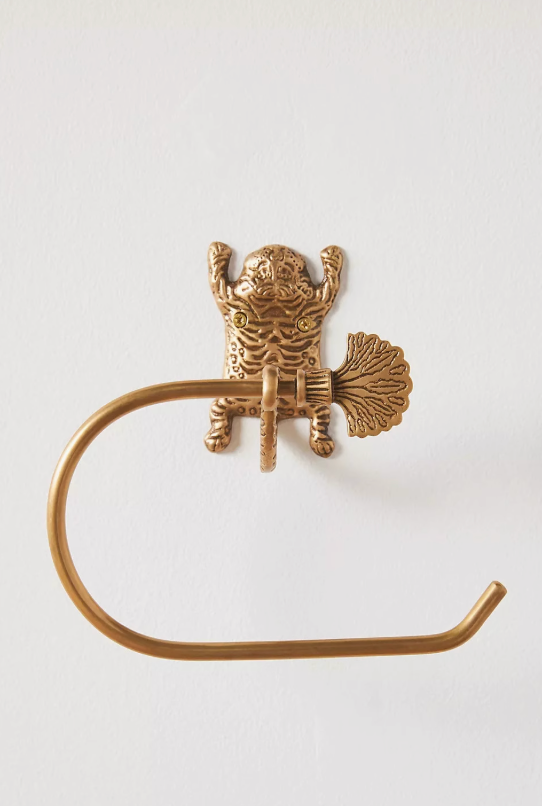 Gold tiger-inspired bathroom accessories set, brass toilet paper holder mounted on white wall.