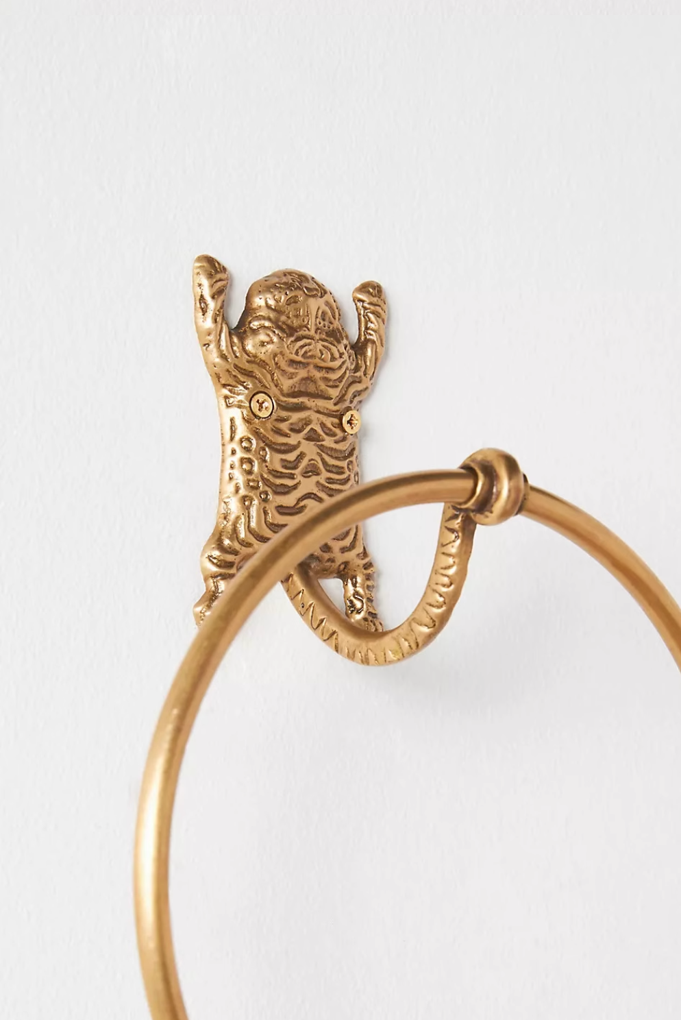 Gold tiger-inspired towel ring, part of bathroom accessories set, detailed metal finish.