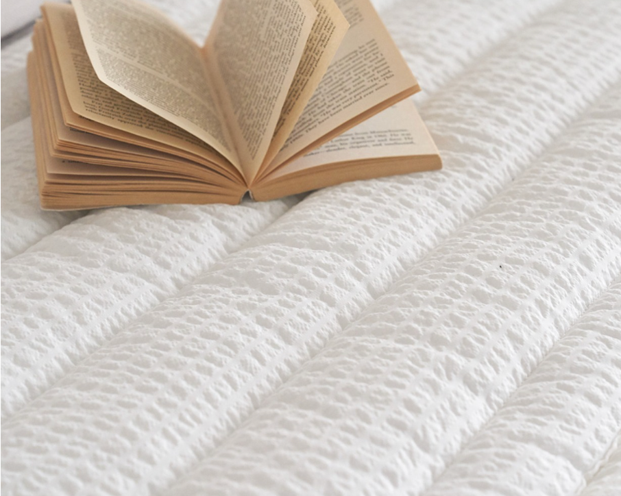Open book on textured white sofa protector and rug set for cozy living rooms.