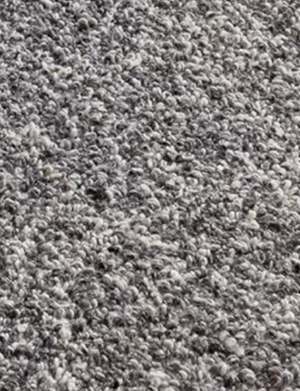 Close-up of gray hand-woven wool shaggy rug texture.