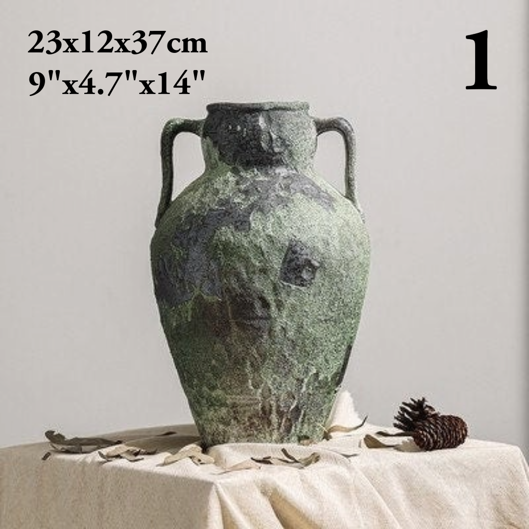 Distressed gray Wabi-Sabi vase with handles on a table.