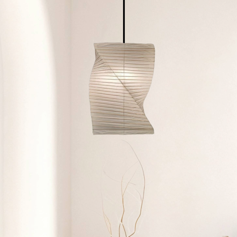 Twisted paper lampshade in off-white, softly lit in a minimalist home decor setting.