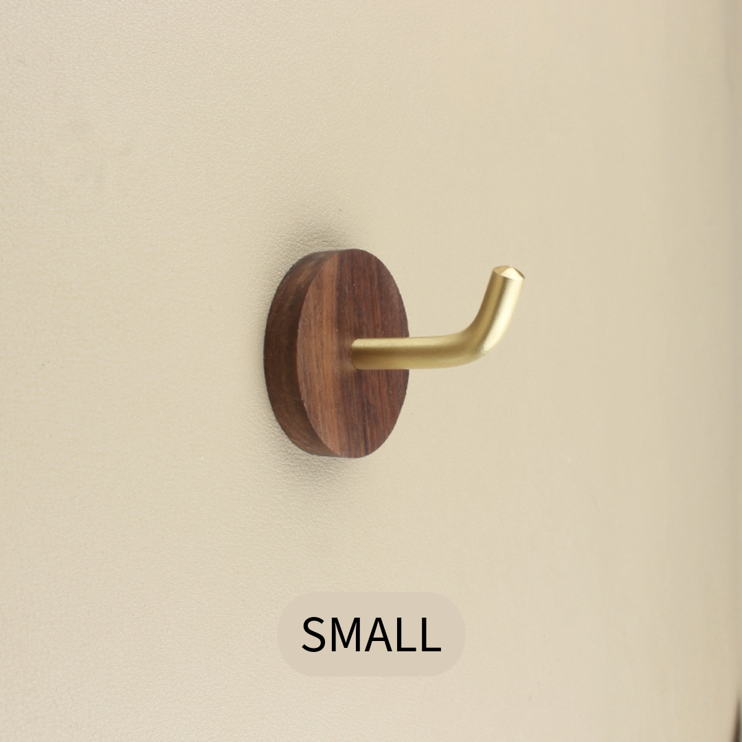Small Walnut & Brass Wall Hook on a neutral textured wall.