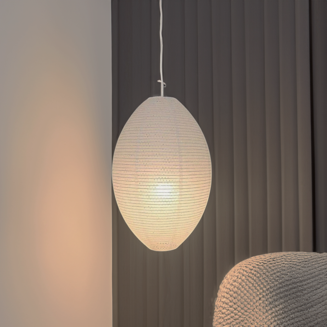 Japanese-inspired Lampshade With Paper Oval casting warm light in a cozy room, featuring various globe shapes in a metal structure.
