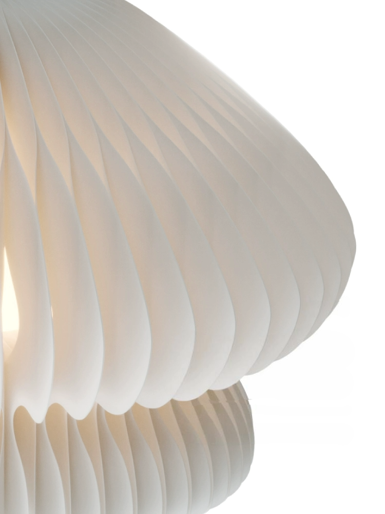 White paper origami mushroom bedside lamp with unique pleats, casting a soft glow.