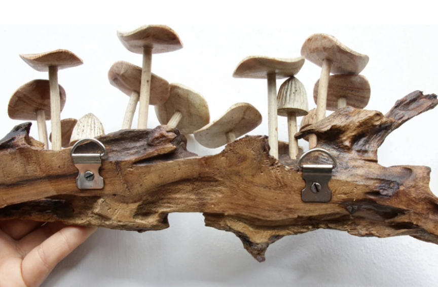 Rustic Mushroom Wall Hanging Sculpture crafted from wood, featuring natural wood tones and mushroom shapes.