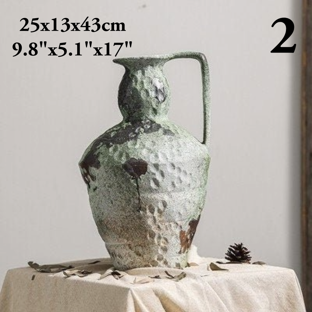 Wabi-Sabi distressed vase, gray and brown tones, ceramic, on a linen tablecloth with dried leaves and pinecone.