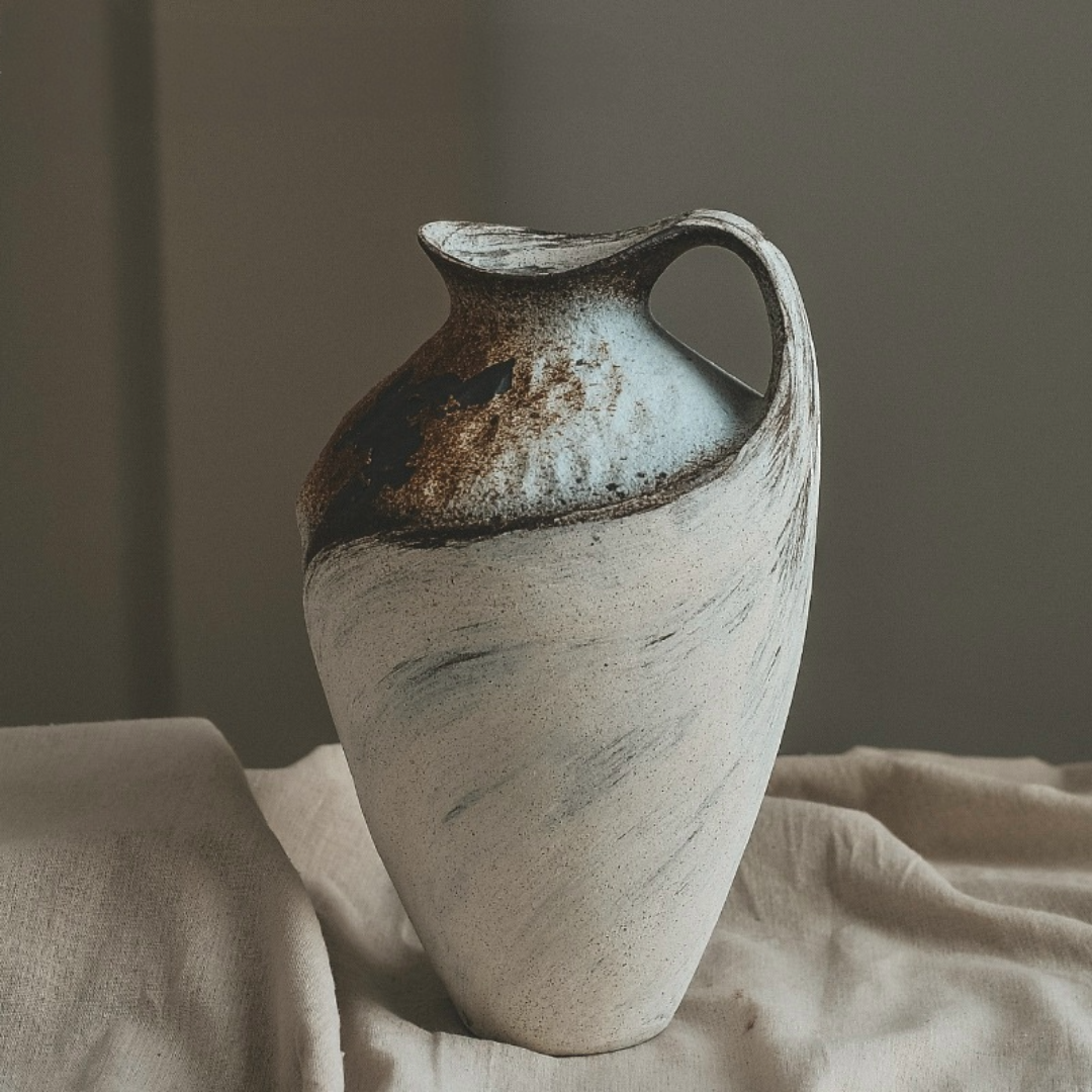 Wabi-sabi clay pot with paintbrush effect in off-white and brown tones, home decor accent.