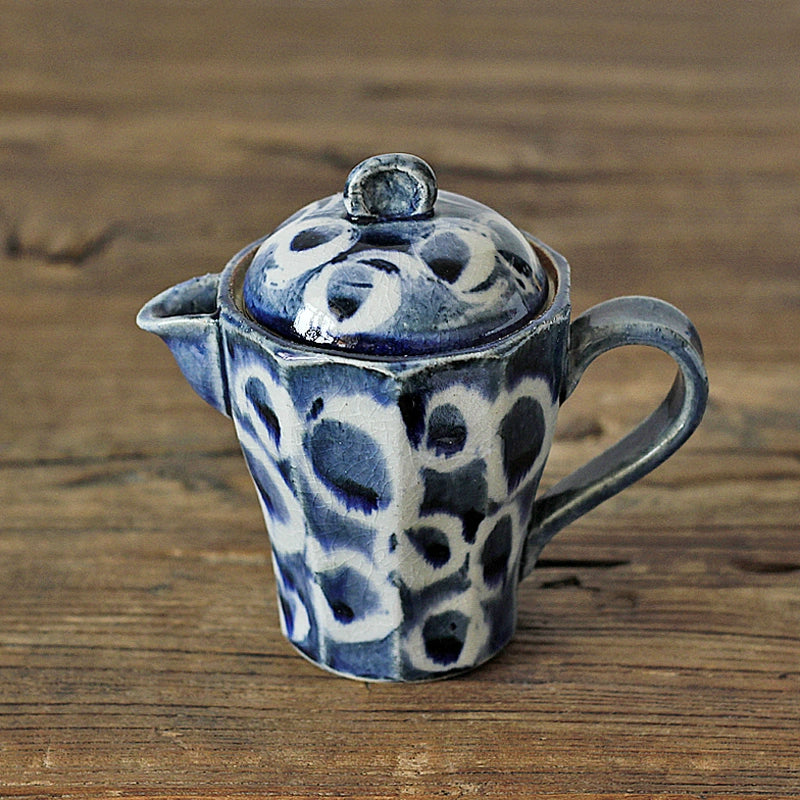 Blue and white patterned ceramic teapot with lid.