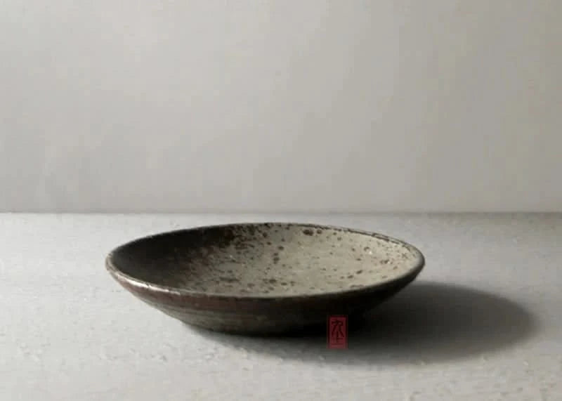 Handmade stoneware brown dinnerware set, speckled beige interior, dark brown rim.