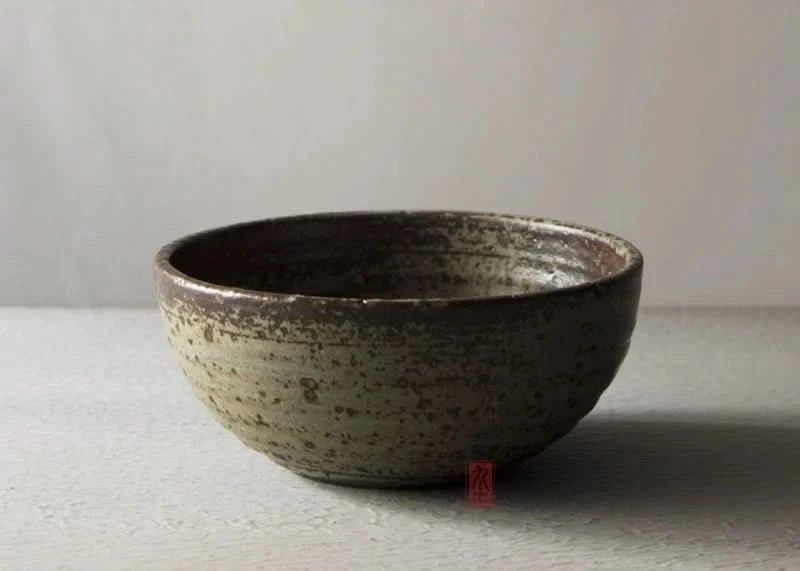 Handmade stoneware brown dinnerware set, rustic textured bowl in light grey and brown.